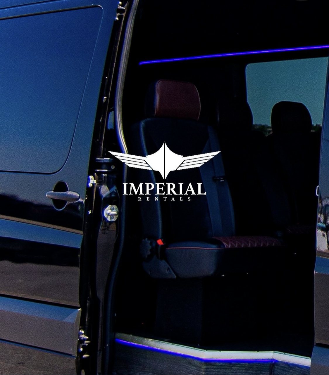 Black Sprinter with the sliding door open, leather seating inside