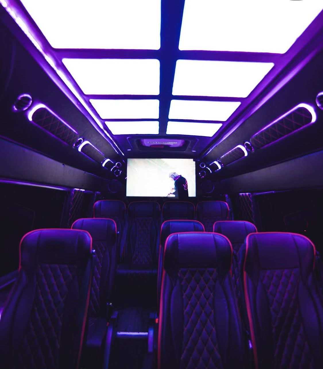 Thirteen quilted seats under the starlight ceiling, screen at the front